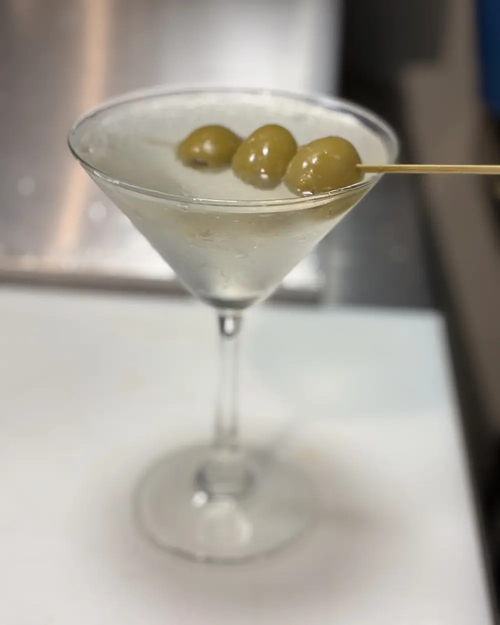 A dirty martini with olives