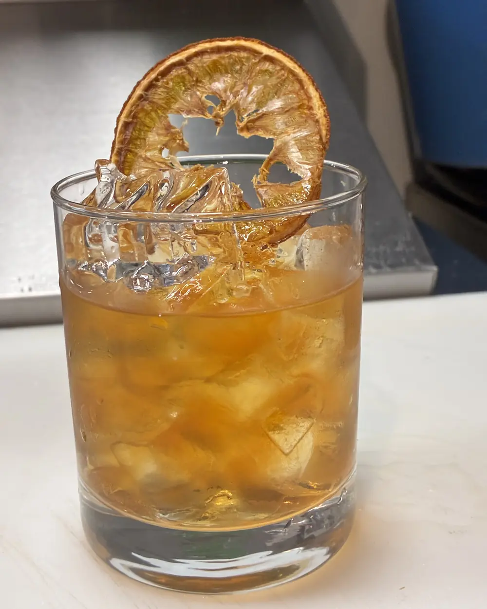 An old fashioned with a dehydrated orange wheel